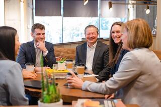 A group of Ferguson Wellman employees sitting at a table over coffee