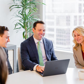 Two Ferguson Wellman employees talking with coffee