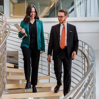 Two Ferguson Wellman employees walking down the office stairs
