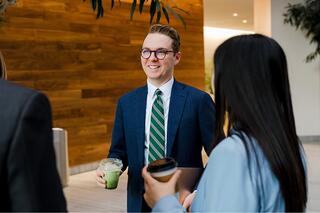 A Ferguson Wellman employee standing with a matcha in hand